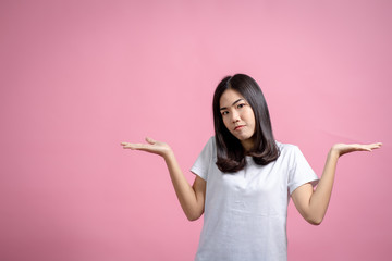 Portrait of a happy girl showing a gesture on a pink background