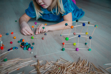 child making geometric shapes, engineering and STEM