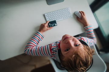 kid using bank card to pay online, modern technology