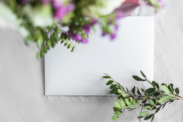 Letter and flowers on a white background. Invitation cards for a wedding or a love letter. Love concept, Happy mother's Day and Valentine's Day. the view from the top.copy space