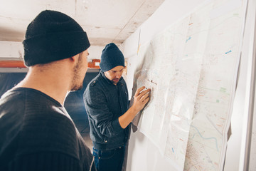 Robbers taking notes on the map