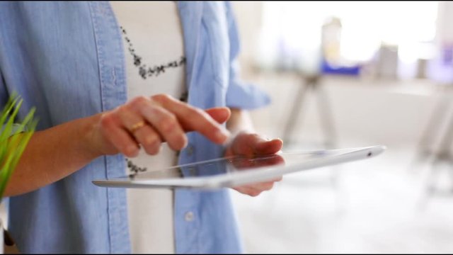 A young woman with tablet planning when moving in new home