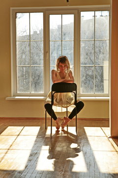 Beatiful young girl model  sit in big room near big window
