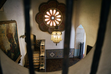 View from a barred window of the interior of a historical Spanish style building in California