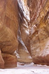 The yellow bent narrow canyon in mountains of Jordan