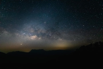 Milky way with night landscape silhouettes mountain