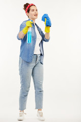 Pretty woman in work-wear shows how to clean windows.