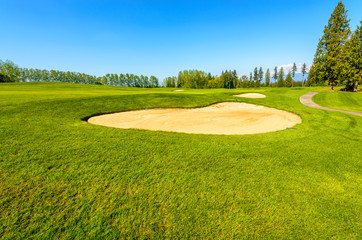 Golf course with gorgeous green and sand bunker