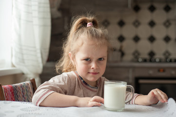 Portrait of a child with a cup of milk