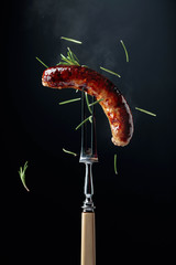 Grilled Bavarian sausage with rosemary.