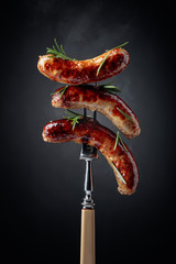 Fototapeta Grilled Bavarian sausages with rosemary. obraz