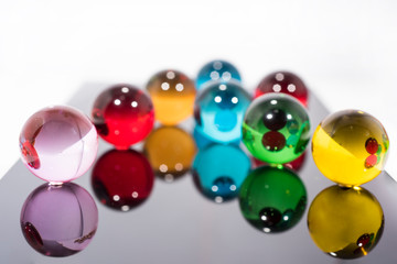 Abstract composition with transparent glass balls and wooden letters.
