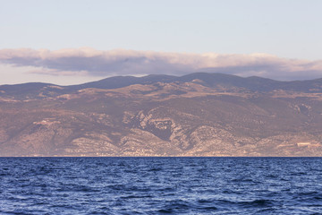 View of the sea and  mountains  on sunset or sunrise. Greatness and tranquility of the landscape