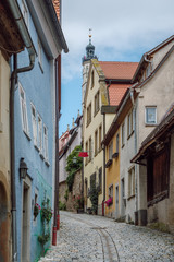 Fototapeta na wymiar View of a narrow street with traditional colorful houses in the old medieval town of Rothenburg ob der Tauber, part of the Romantic Road in Germany, region Franconia, Bavaria. 