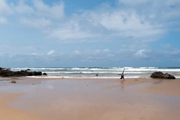 Child doing handstands at the beach at Phillip Island, Victoria Australia