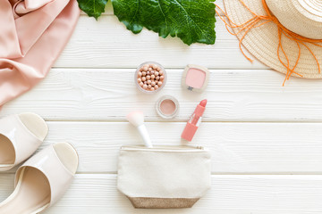Women fashion concept. Dress, shoes, cosmetics on white wooden background top-down frame copy space