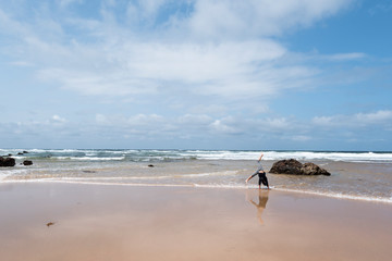 Fototapeta na wymiar Child doing handstands at the beach at Phillip Island, Victoria Australia