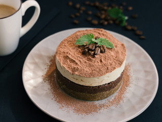  Tiramisu on a wooden plate. Coffee and cinnamon. Raw dessert