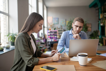 Fototapeta premium Girl with a tablet and a man at a computer.