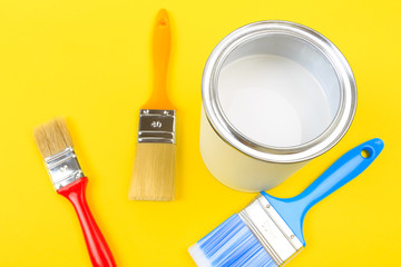 White Paint Can with Brushes Top View On Yellow Background. - Image