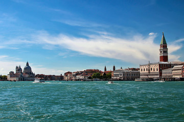 Fototapeta na wymiar Returning from the island of Lido to the vaporetto, you can see Venice from a completely different angle. Visible landmarks include: the Palazzo Ducale, Basilica di Santa Maria della Salute and others
