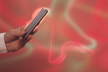 mobile phone in hand with red background