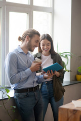 Smiling man and woman looking at the tablet