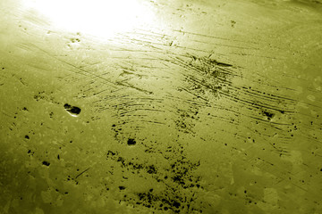 Part of bronze sculpture close-up in yellow tone.