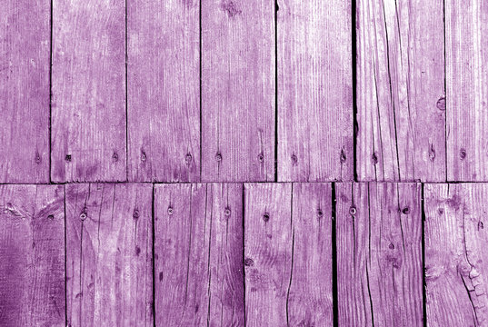 Old grungy wooden planks background in purple tone.