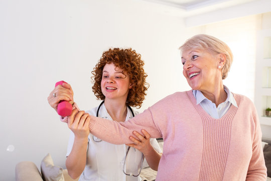 Senior woman after stroke at nursing home exercising with professional physiotherapist. Elder woman returning to good health. physiotherapist nurse helping an elderly women physical rehabilitation