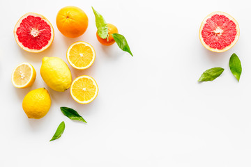 Fresh citrus frame. Oranges, tangerines, grapefruits, leaves on white background top-down copy space