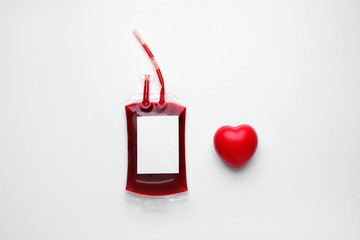 Blood pack for transfusion and heart on white background