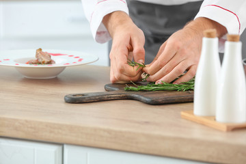Male chef cooking in kitchen, closeup