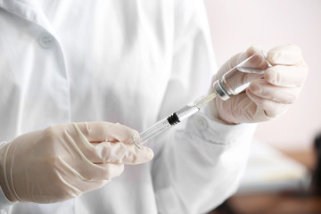 Cosmetologist with syringe and ampule with filler, closeup