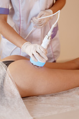 Hardware cosmetology. Body care. Spa treatment. Ultrasound cavitation body contouring treatment. Woman getting anti-cellulite and anti-fat therapy in beauty salon.