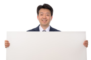 An Asian businessman holding a blank message board.