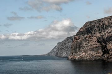 Fototapeta na wymiar Huge majestic cliffs of Los Gigantes in an unusual light. Only the sea and the rocks.