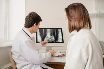 Young man doctor explain to the woman patient