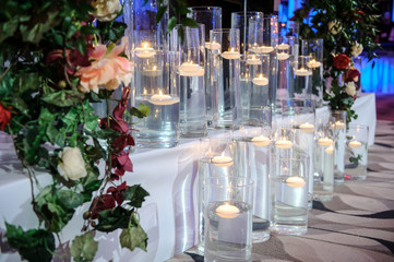 transparent glasses with candles in interiors