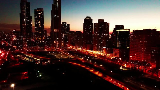 Aerial of urban skyscrapers at sunset. 4K
