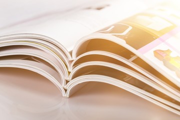 Open new magazines lying on the desk