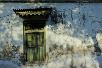 Classic wooden window frames with aged walls, in a warm beam of light. 