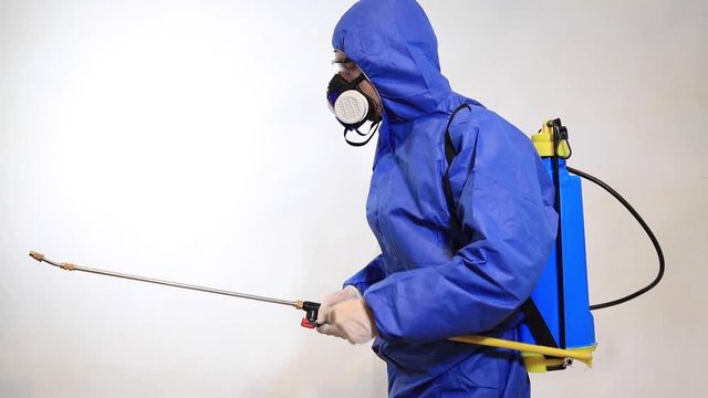 Pest Control Worker In Protective Workwear With Pesticides Sprayer Over White Background