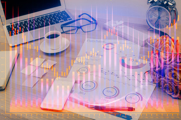 Double exposure of chart and financial info and work space with computer background. Concept of...