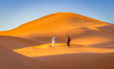 Fototapeta na wymiar Two Berbers in Sahara desert, Merzouga, Morocco