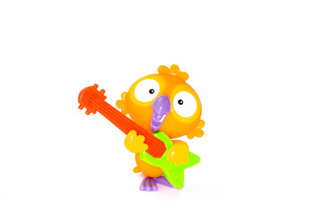 Parrot with guitar toy figurine on white background