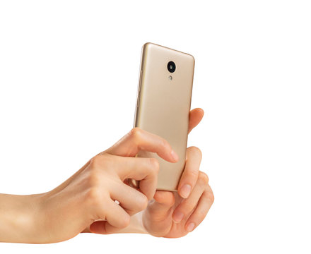  Female hands take a photo on a golden smartphone with one camera on a white background.