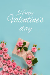Fototapeta na wymiar Valentine's day banner.postcard favorite.Festive wreath of roses decoration with gifts and pink roses on a blue background. copyspace.flat lay