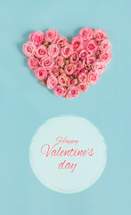 Valentine's day banner.Holiday card with a heart of pink roses on a blue background.Congratulation.Creative.diy.Women's day.Mother's day.love.postcard.Banner.Vertically.