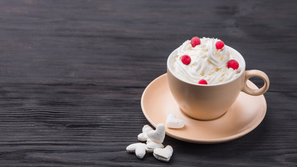 Cup of coffee with decoration -marshmellow, cream, berries